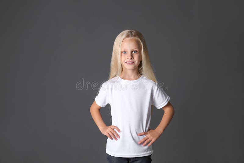 Cute little girl in t-shirt on dark background royalty free stock photos Cute little girl in t-shirt on dark background royalty free stock photos