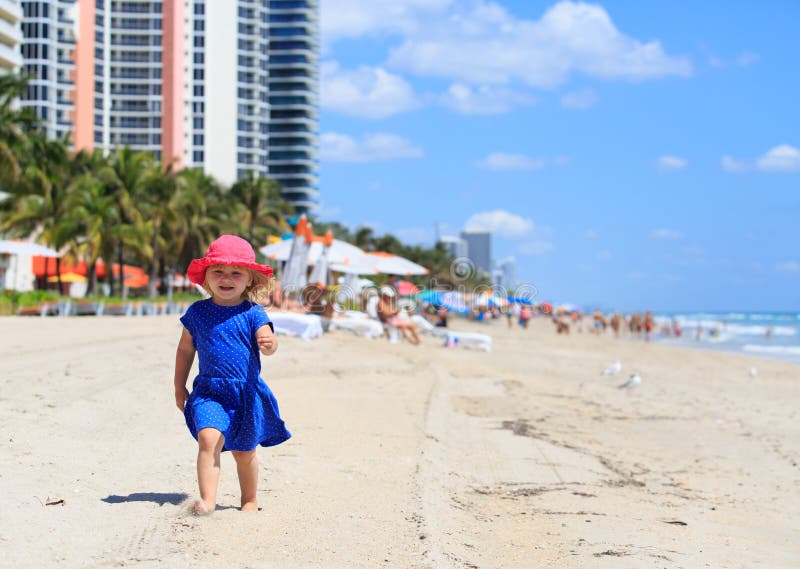 Cute little girl walk on summer beach