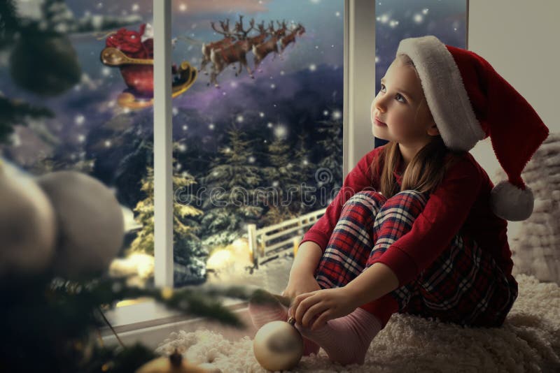 Cute Little Girl on Window Sill at Home Waiting for Santa Claus ...
