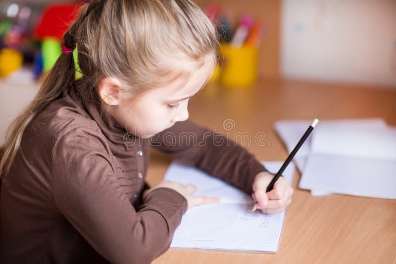 Cute little girl writing her homework royalty free stock photos