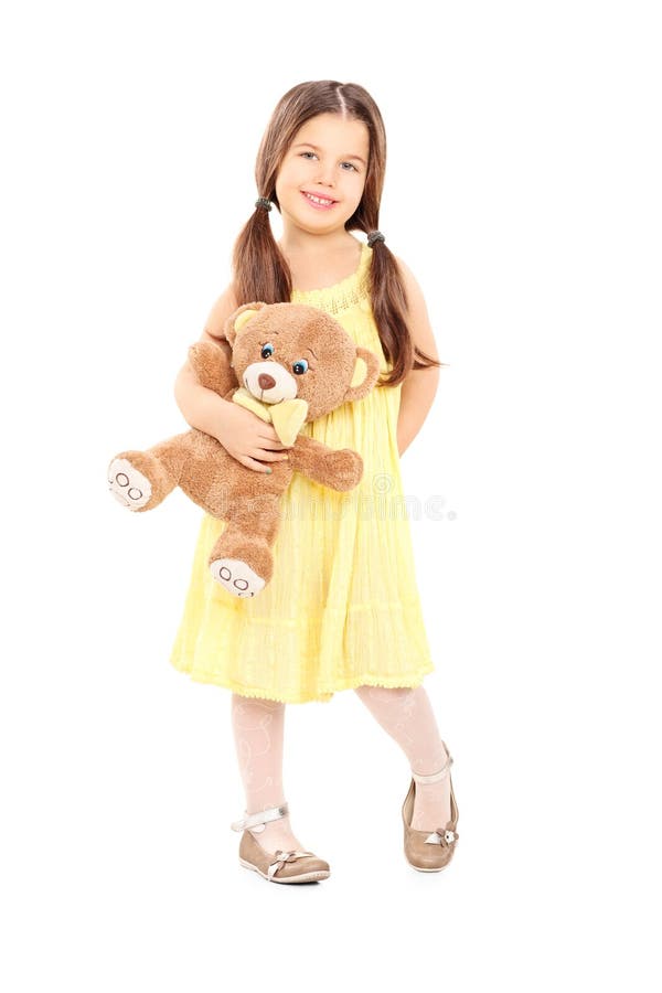 Cute Little Girl in Yellow Dress Holding a Teddy Bear Stock Photo ...