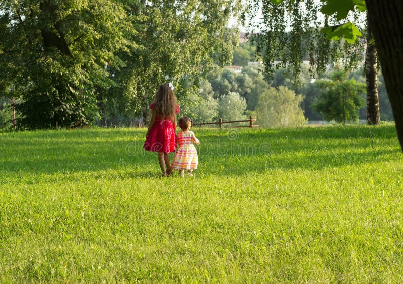 Cute little girls having fun at summer day