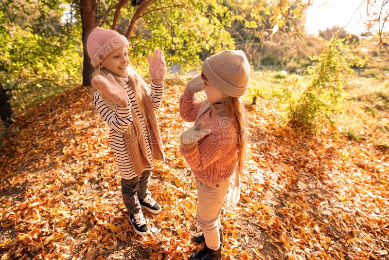 Cute little girls playing in autumn park royalty free stock photos Cute little girls playing in autumn park royalty free stock photos