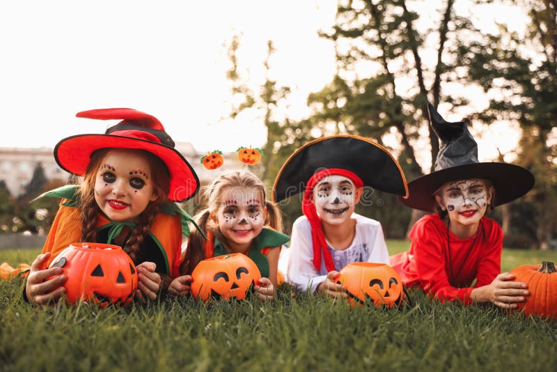 Cute Little Kids with Pumpkin Candy Buckets Wearing Halloween Costumes ...