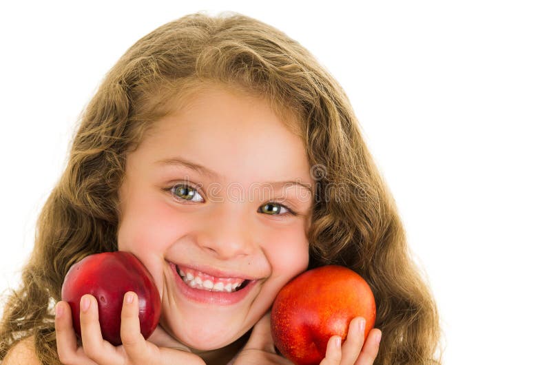 Cute little preschooler girl holding two peaches