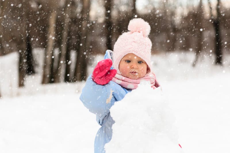 Cute little toddler girl play in winter