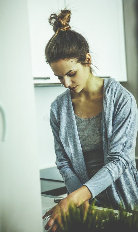 Cute lovely young woman standing and washing dishes royalty free stock photos Cute lovely young woman standing and washing dishes royalty free stock photos