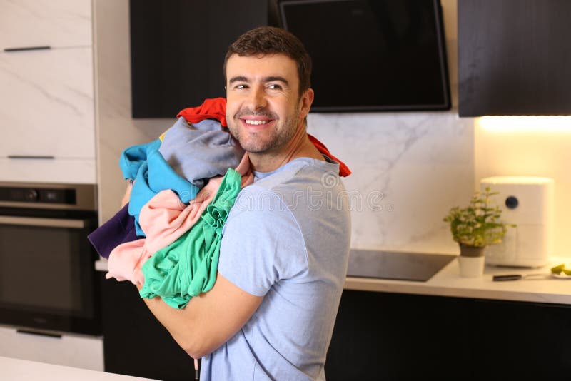 Cute man doing the laundry stock image. Image of adult 263512915