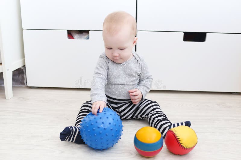 Cute 6 month baby girl plays balls stock image Cute 6 month baby girl plays balls stock image