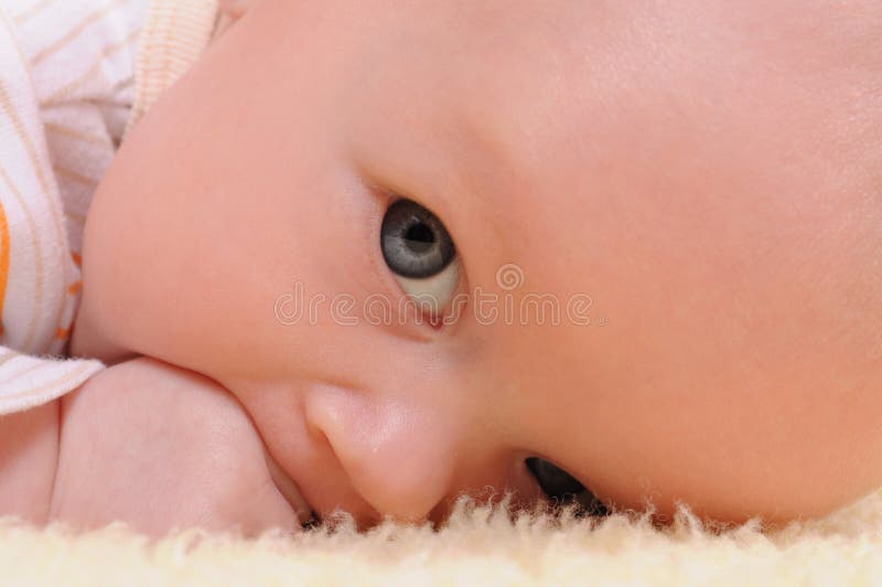 Cute baby eating her hand