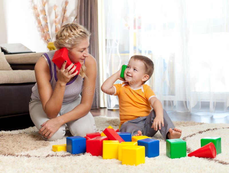 Cute mother and kid boy playing together royalty free stock image
