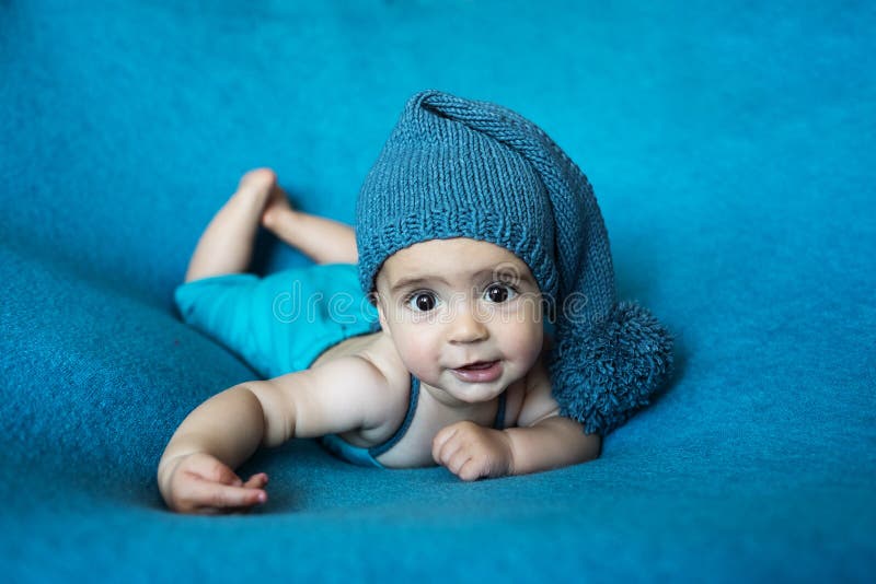 Cute Newborn Baby in the Blue Hat. Happy Baby on a Blue Background ...