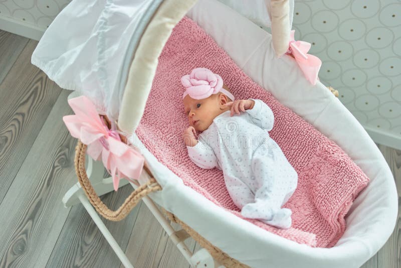 Cute newborn baby girl in footed pajama.