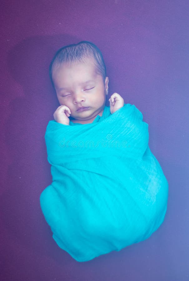 Cute Newborn Baby Sleeping in Baby Wrap in Unique Style from Top Angle