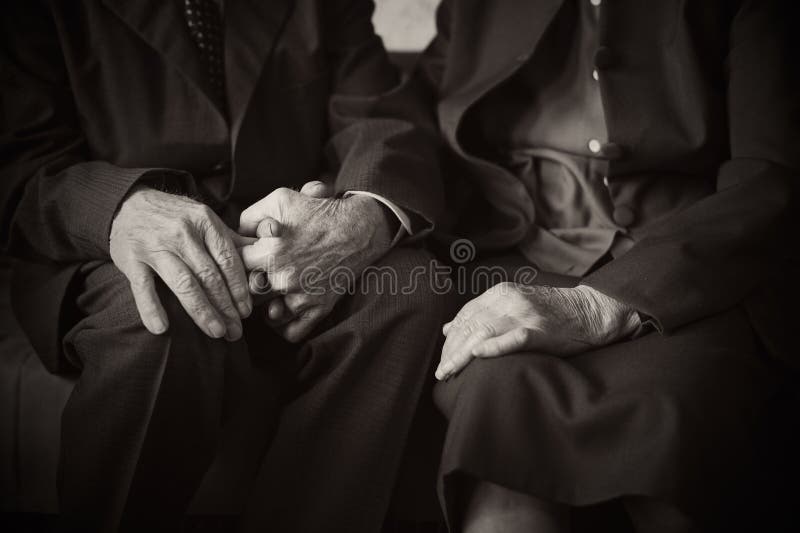 Cute 80 plus year old married couple posing for a portrait in their house. Love forever concept