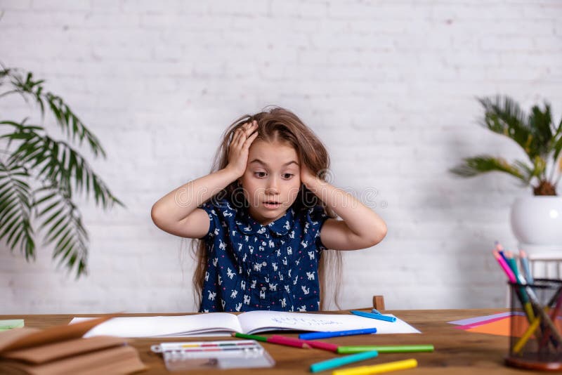Cute portrait of little kid girl drawing by multi-colored pencils. Concept of kids hobby or childhood, happy lifestyle royalty free stock images Cute portrait of little kid girl drawing by multi-colored pencils. Concept of kids hobby or childhood, happy lifestyle royalty free stock images