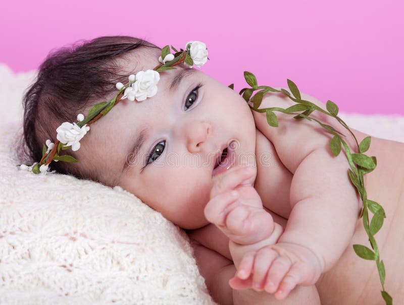 Cute, pretty, happy, chubby baby girl portrait, naked or nude, on a fluffy blanket. Wearing a floral wreath headband or headdress. Looking up. Four months royalty free stock photo Cute, pretty, happy, chubby baby girl portrait, naked or nude, on a fluffy blanket. Wearing a floral wreath headband or headdress. Looking up. Four months royalty free stock photo