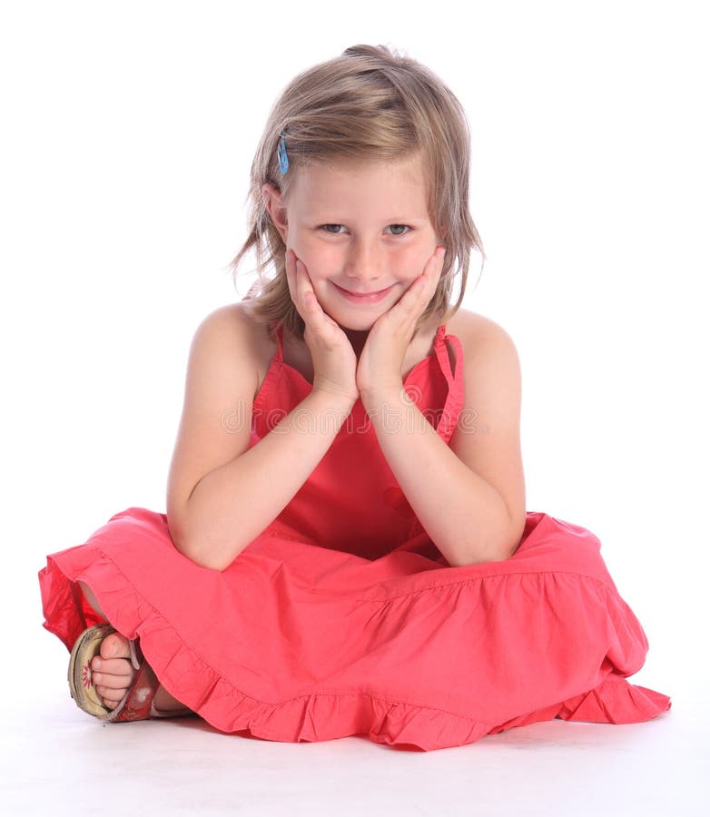 Cute primary school girl sitting cross legged