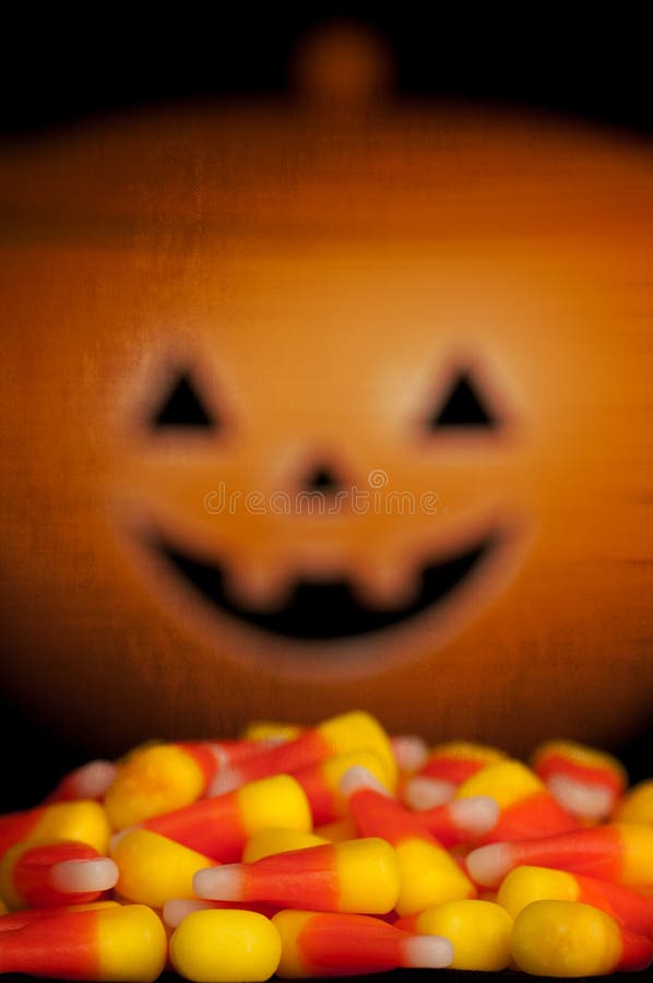 Cute Pumpkin Smiling Over Candy Corn