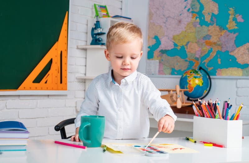 Cute pupil with funny face schooling work. Home school for pupil. Kids gets ready for school. Elementary school stock photography