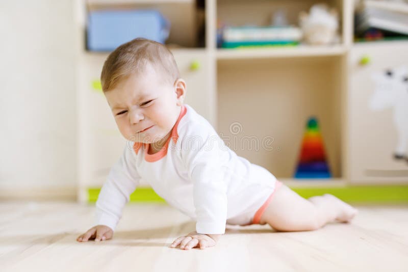 Cute Sad Crying Baby on Ground in Kids Room. Stock Image - Image of ...