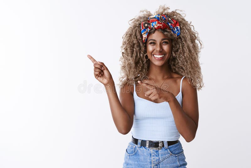 Cute sincere, friendly-looking blond curly-haired hipster woman with piercing, squinting joyfully, sharing cool link royalty free stock image Cute sincere, friendly-looking blond curly-haired hipster woman with piercing, squinting joyfully, sharing cool link royalty free stock image