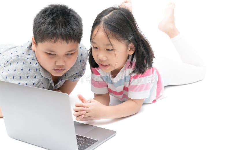 Cute sister and young brother play laptop isolated royalty free stock photo Cute sister and young brother play laptop isolated royalty free stock photo