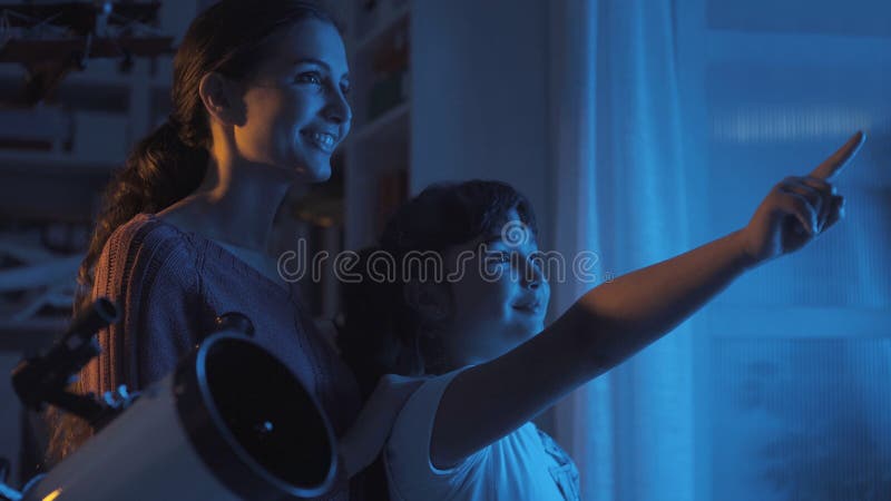 Cute sisters watching the stars with a telescope royalty free stock photos Cute sisters watching the stars with a telescope royalty free stock photos