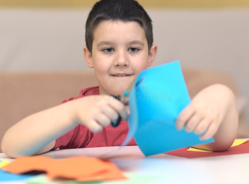 Cute Smiling Boy is Cutting Paper Using Scissors Stock Image Image of