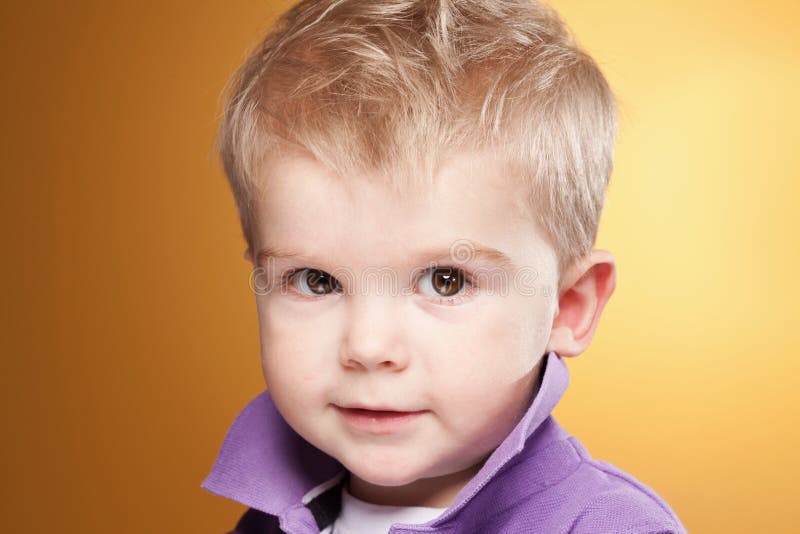 Cute smiling little boy looking at camera