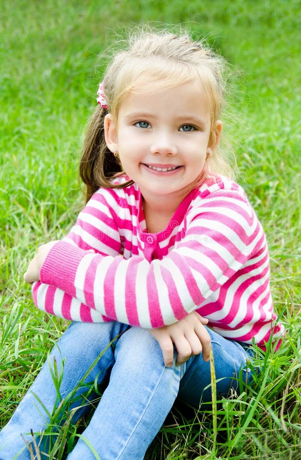 Cute Smiling Little Girl Lying in Grass on the Meadow Stock Image ...