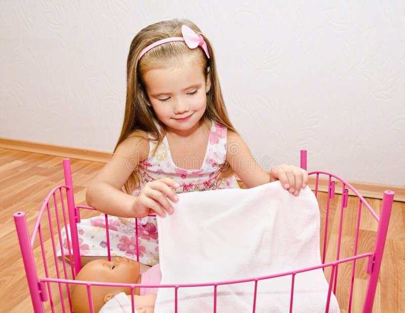 Little Girl Playing With Doll Stock Photo | Getty Images