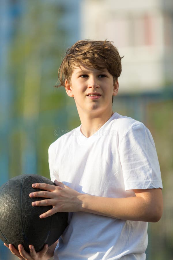Cute Sporty Teenage Boy Playing Basketball Outdoors Preparing for ...