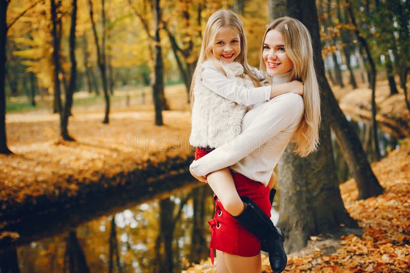 Cute and stylish family in a autumn park stock photos