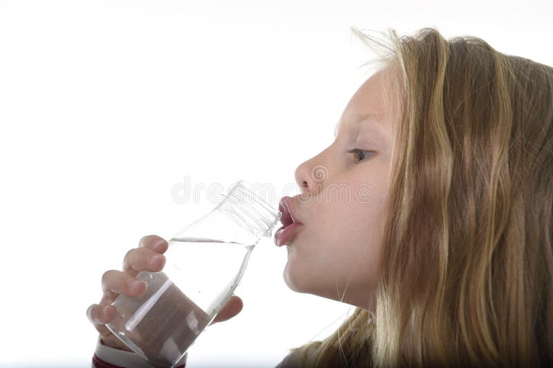 Cute sweet little girl with blue eyes and blond hair 7 years old holding bottle of water drinking