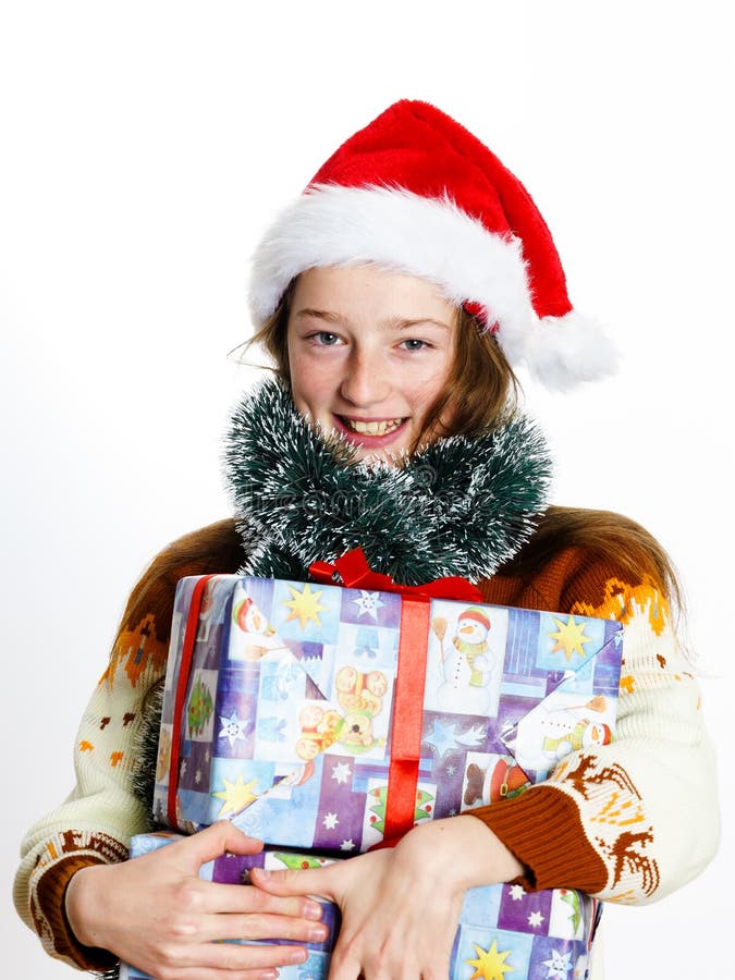 Cute teenage girl in santa red hat with gift box