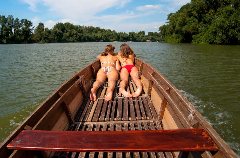 Cute teenage girls sunbathing in the boat