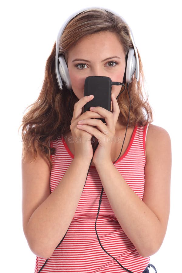 Cute teenager girl listens to music on headphones
