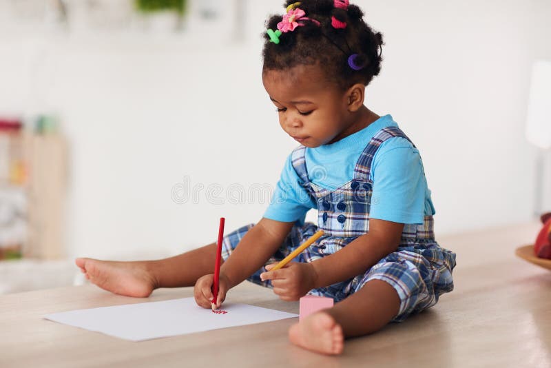 Cute toddler baby girl drawing with pencils using both hands