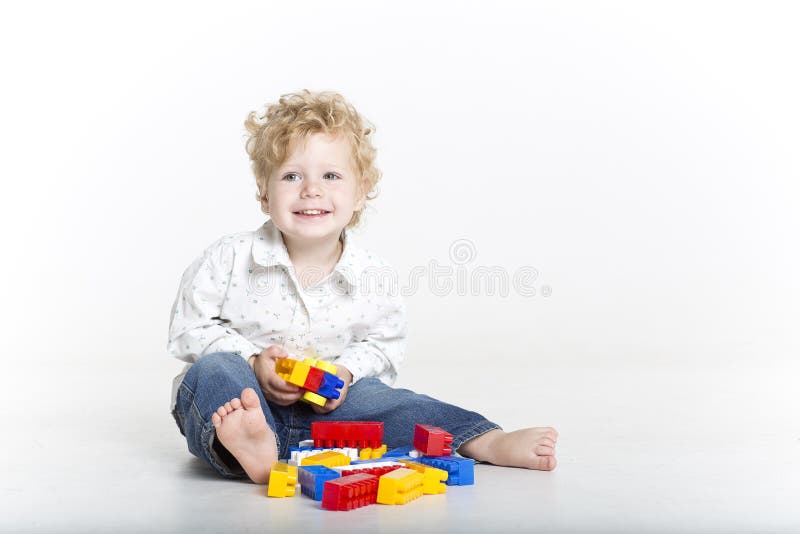 Cute toddler is building with legos