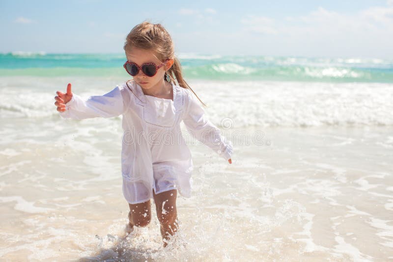 Young Children Picking Up Seashell on Beach Stock Photo - Image of ...