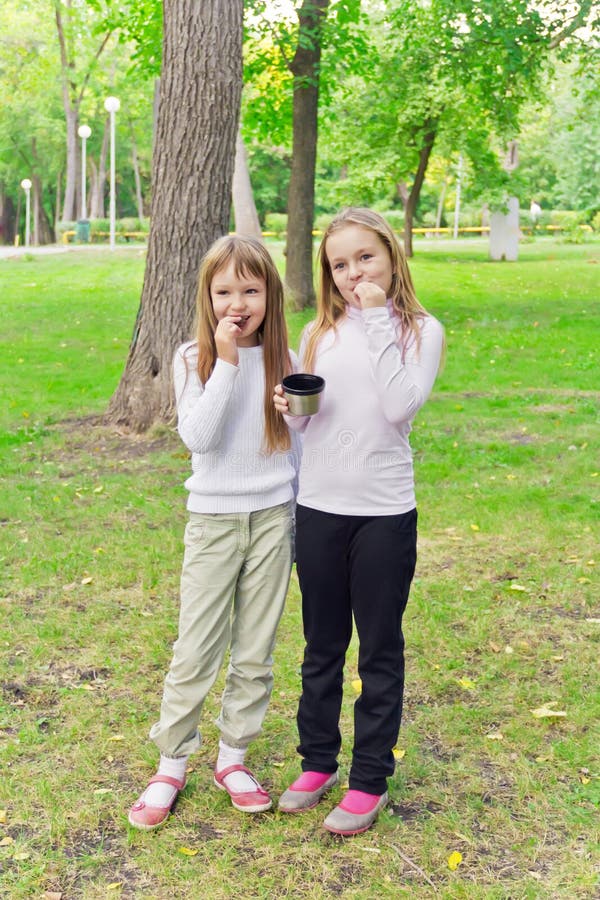 Cute two eating girls stock image. Image of playing, nine 58958439