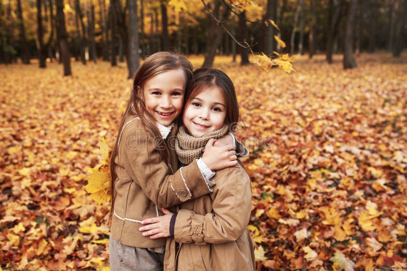 Cute two little sisters hugging in autumn park outdoor royalty free stock photo Cute two little sisters hugging in autumn park outdoor royalty free stock photo