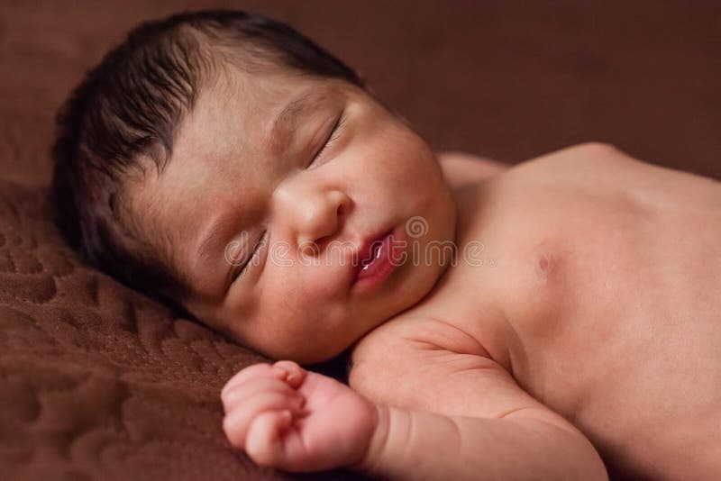 Cute two weeks old newborn baby girl without clothes, naked or nude, sleeping. Close up portrait of a cute two weeks old newborn baby girl without clothes, naked stock photography Cute two weeks old newborn baby girl without clothes, naked or nude, sleeping. Close up portrait of a cute two weeks old newborn baby girl without clothes, naked stock photography