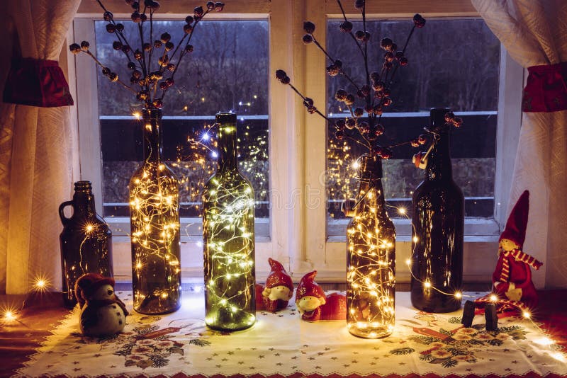 Cute and warm Christmas decoration set with vintage beer bottles and wine bottles filled with micro led party lights.