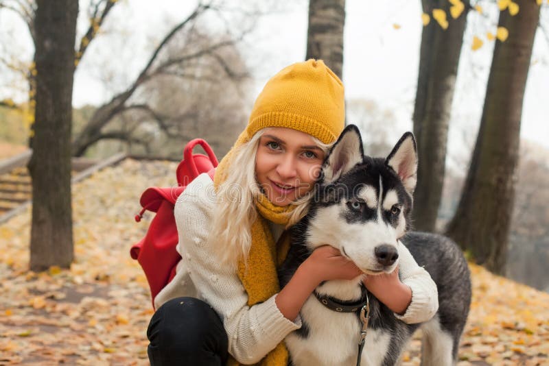 Cute woman and dog husky walking outdoor stock photo Cute woman and dog husky walking outdoor stock photo