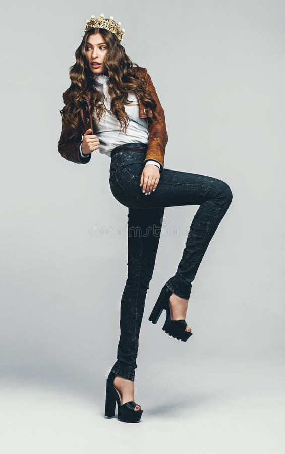 Cute woman in jeans and golden crown royalty free stock photo