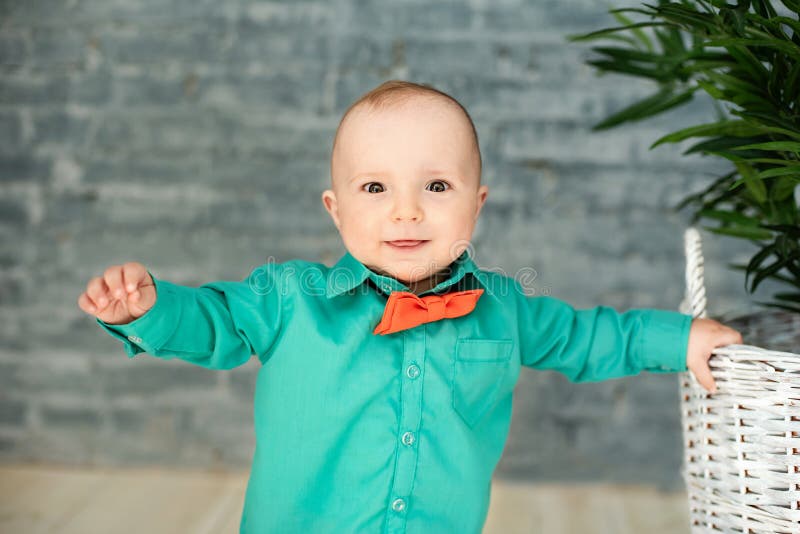 cute 1 year old boy stands. Child with happy expression. sweet baby boy, closeup portrait of child, cute toddler with grey eyes.