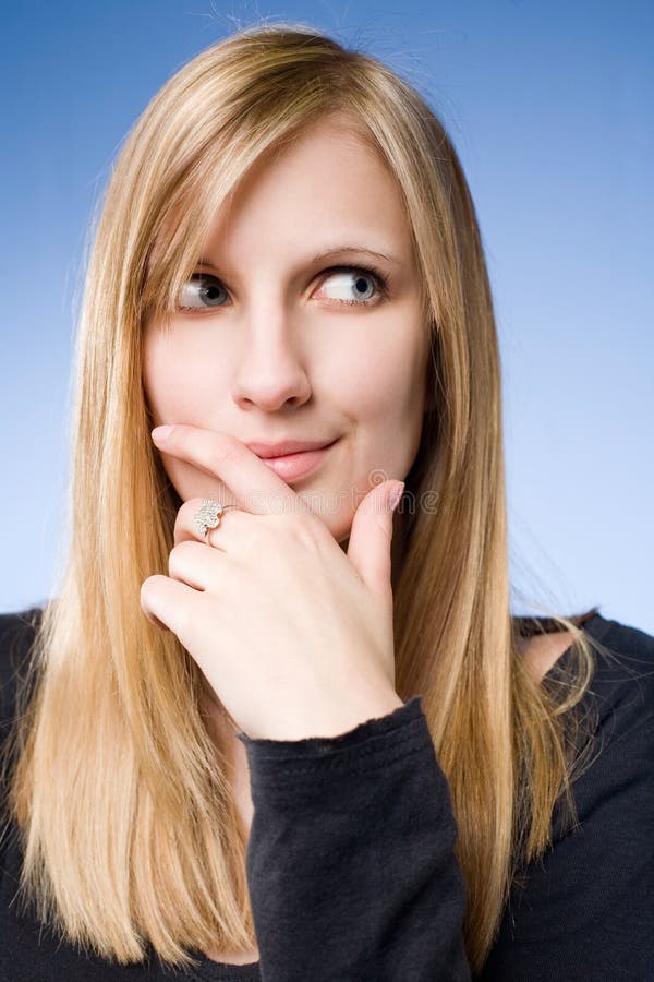 Cute young blond pondering. royalty free stock images
