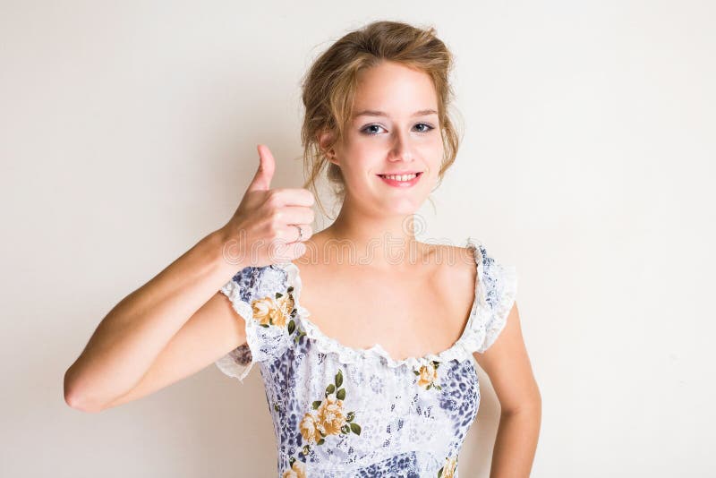 Cute young blond showing thumbs up. stock photos